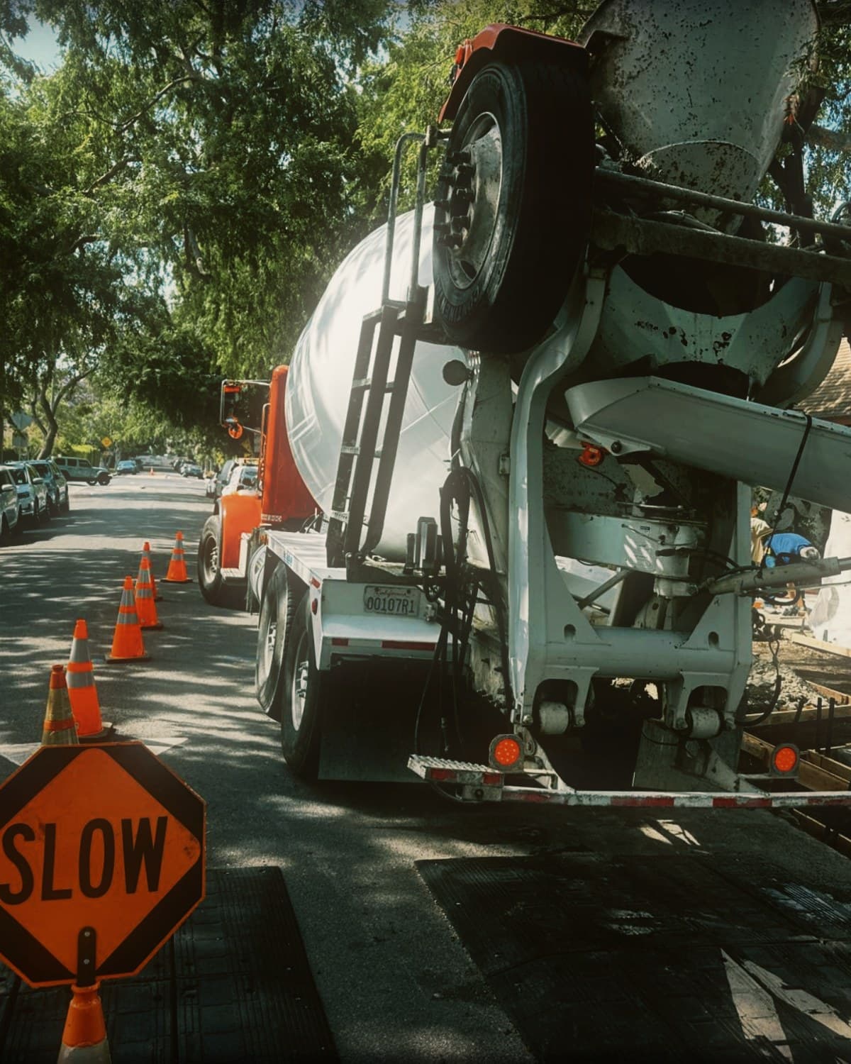 A CAT mini excavator working in the street during right-of-way sidewalk replacement in West Hollywood